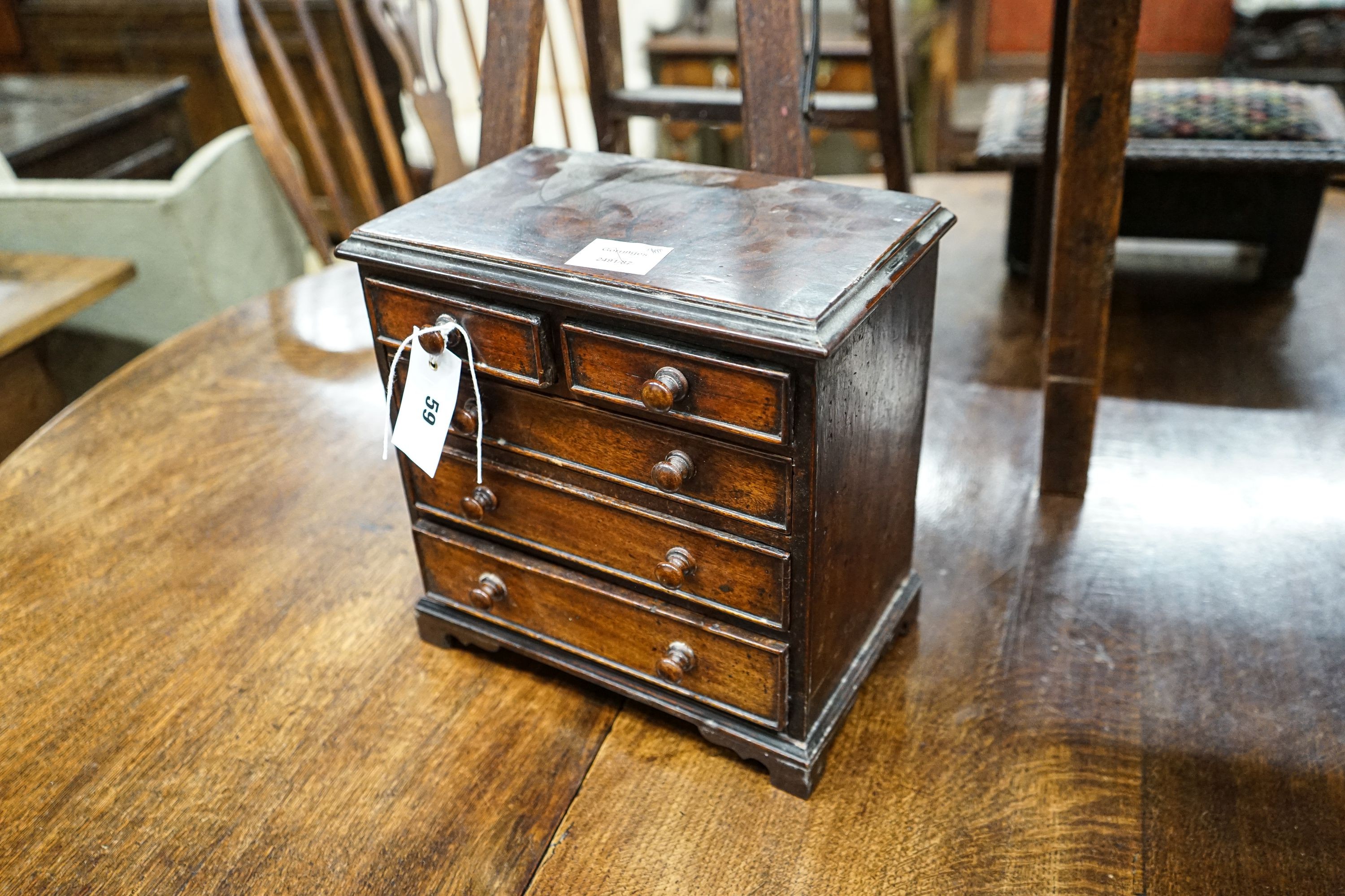 An antique mahogany miniature chest of drawers, width 27cm, depth 16cm, height 27cm